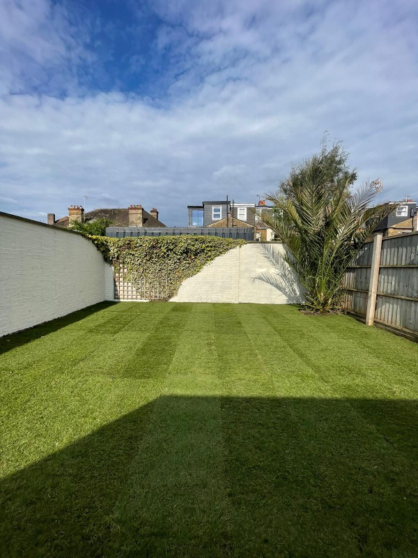 Levelled lawn with new turf and neat edges.