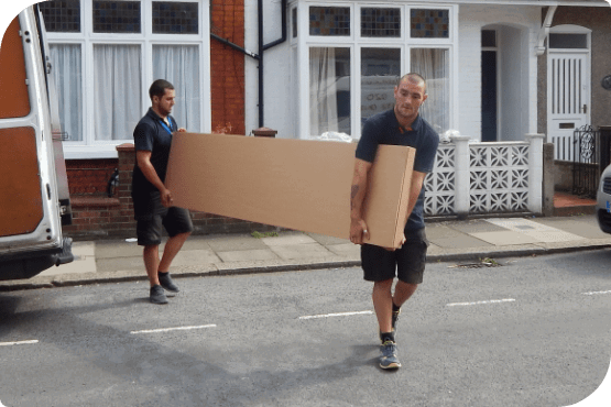 Two professional movers unloading a flat-pack from delivery van.