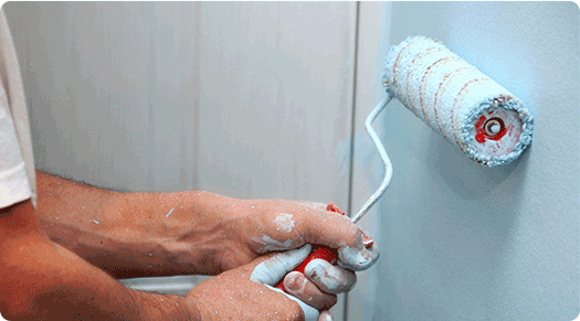 Handyman painting a wall