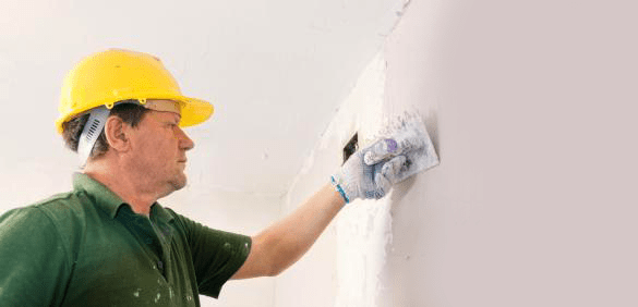 Fantastic Handyman plastering a wall