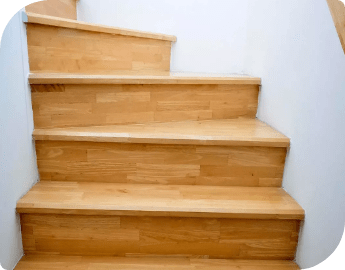 Wooden stairs with white walls beside them