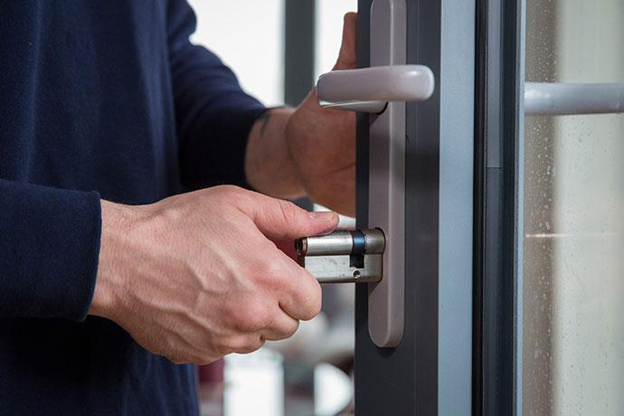 Emergency locksmith repairing a door lock in a London property