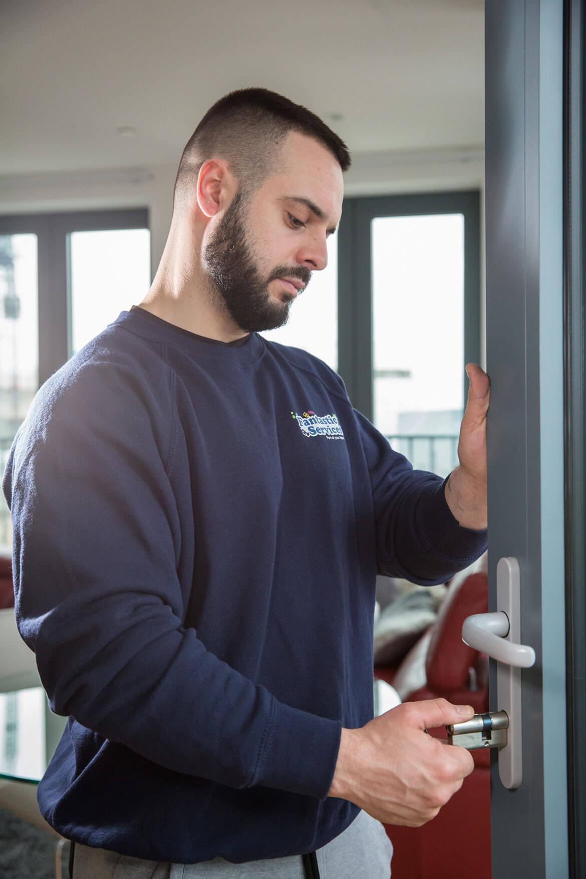 Emergency locksmith repairing a door lock in a London property