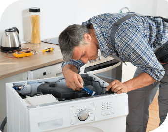 appliance engineer fixing a washing machine