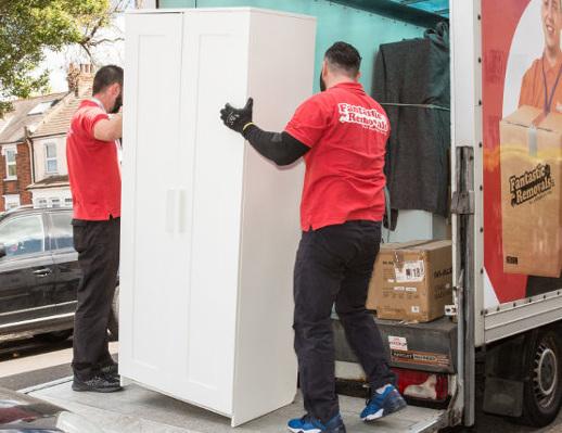 Professional removals team moving boxes during property relocation