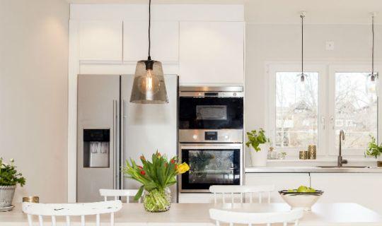 a kitchen with a fridge and a range cooker