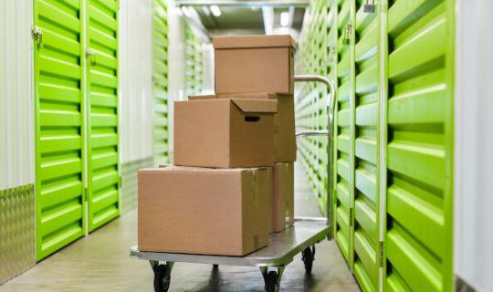 a storage facility and a cart full of boxes