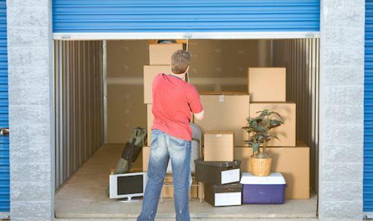 a man opening up the door of his storage unit