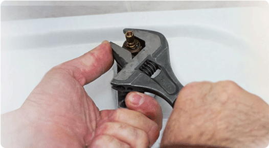 Plumber fixing a sink leaking pipe