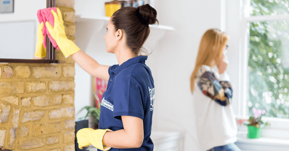 A couple of pros cleaning a kitchen.