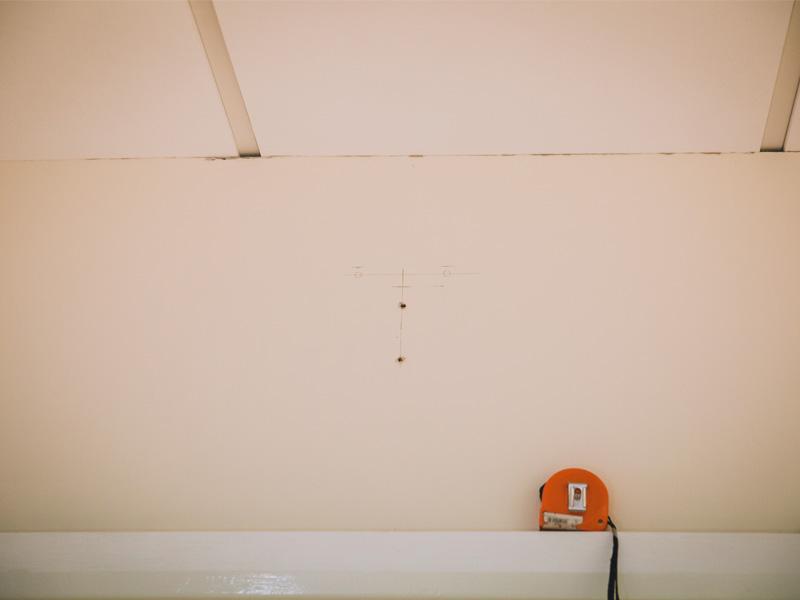 marking the drilling holes for a TV wall mounting service