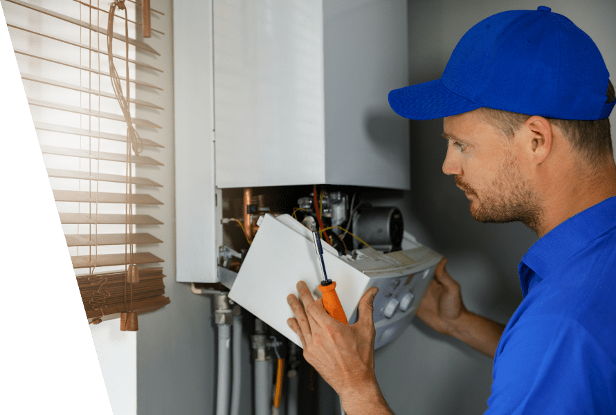 A professional that disassembled the bottom part of a boiler and inspecting.