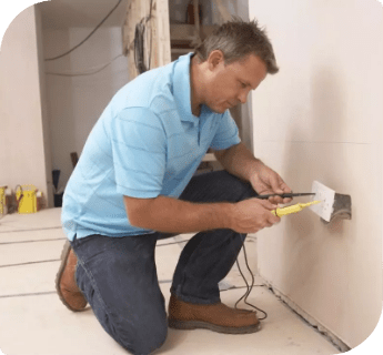 А professional testing the electricity in an electrical socket