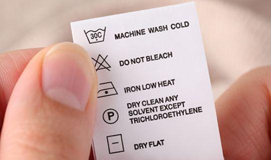 a close-up image of a fabric care label with cleaning instructions