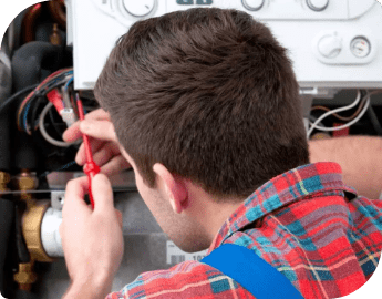 A professional working on servicing a boiler