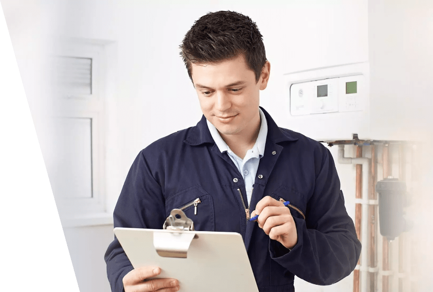 A boiler service expert writes the gathered data on a paper attached to a folder