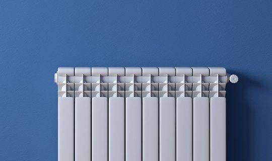 an image of a radiator next to a blue wall