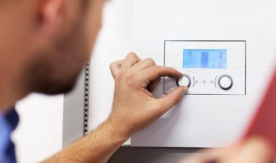 a man adjusting the heat by using a mounted control unit with buttons