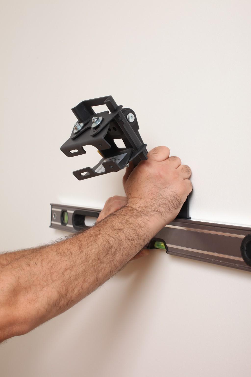 handyman mounting a TV