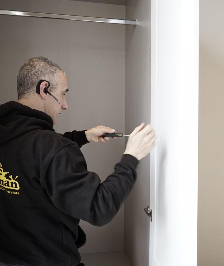 handyman fixing wardrobe