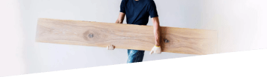 Laminate floor planks and tools on the floor of a room, prepared for laminate floor fitting service.