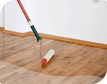 wood-floor-buffing-and-coating Wood floor, partially coated with a pain roller.