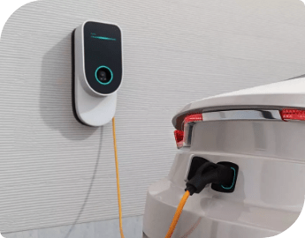 Electric car being charged with a wall-mounted charger.