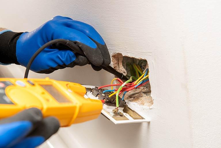Electrician checking the electrical safety of a London property