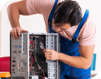 IT specialists repairing the internal components of a desktop computer.