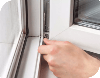 Picture of the hand of a professional who is repairing the hinges of a window