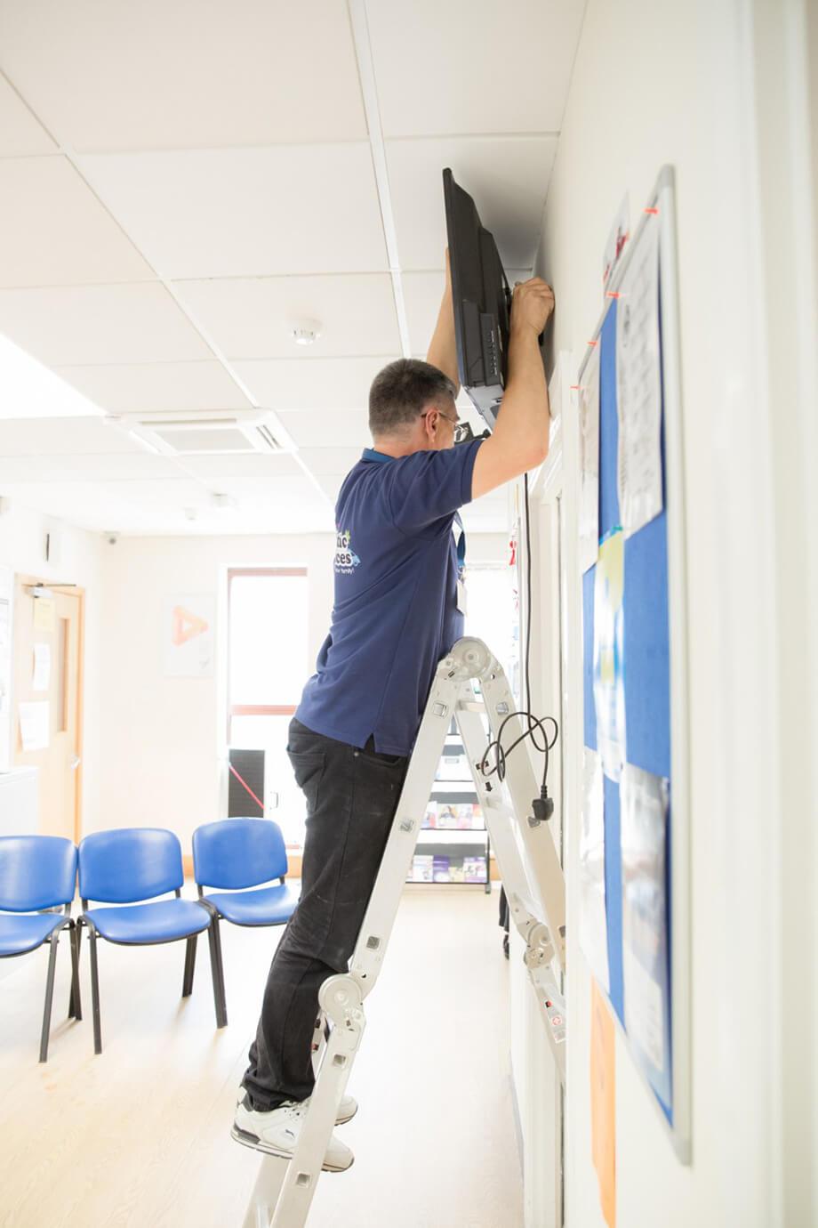 Handyman mounting a TV