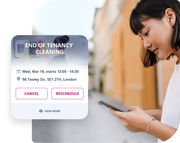 An image of a woman using the GoFantastic mobile app to book end of tenancy cleaning services. The woman is seen holding her smartphone and interacting with the app, selecting the end of tenancy cleaning service from the options provided. She appears focused and engaged in the app, indicating her intent to book the service. The app interface is displayed on the screen, showing the various features and options for booking the cleaning service.