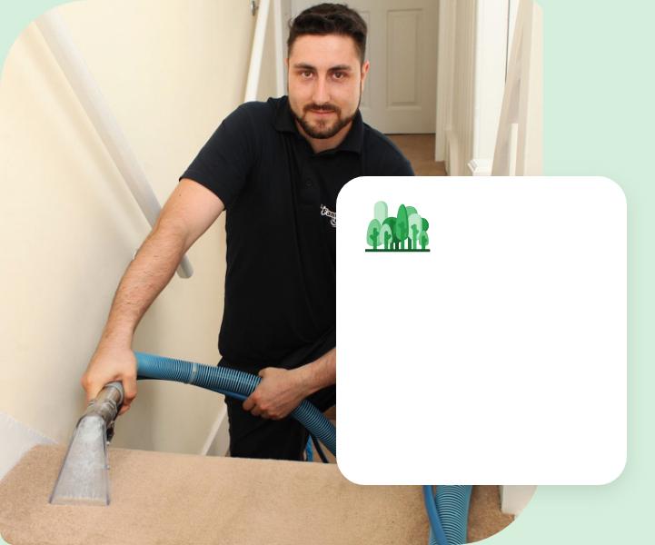 A Fantastic Services carpet cleaning expert wearing a blue uniform utilising a hot water extraction industy-grade machine to clean a carpeted staircase.