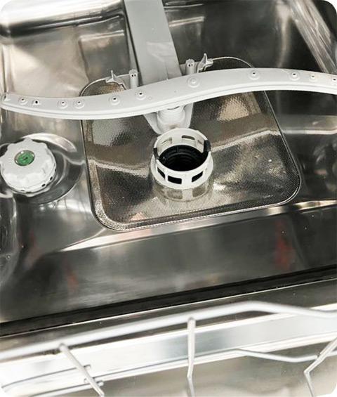 An image of a sparkling clean inside of a dishwasher, showing a pristine and well-maintained appearance. The interior of the dishwasher is free from any visible food debris, grease, or stains. The racks, walls, and other surfaces are gleaming, indicating a thorough cleaning. The inside of the dishwasher looks fresh and ready for use, with no signs of dirt or grime. The cleanliness ensures optimal performance and efficiency of the dishwasher.