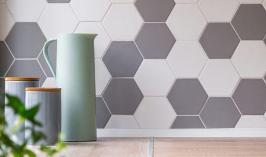 grey and white hexagonal wall tiles and a kitchen worktop