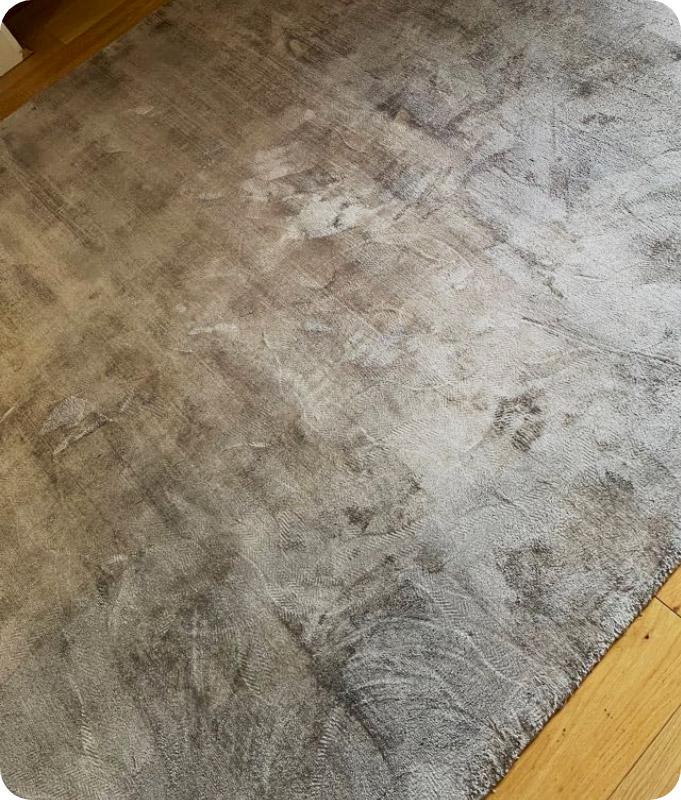 A black-grey-white pattern area rug that looks perfectly cleaned and revitalised after our professional carpet and rug cleaning service.