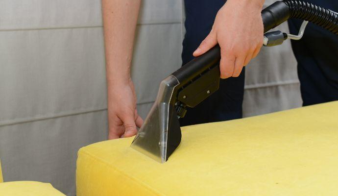 Hand holding upholstery cleaning tool