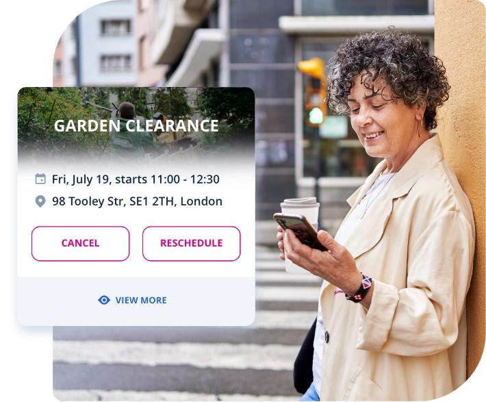 Photo of a middle-aged woman booking garden clearance service through her smartphone.