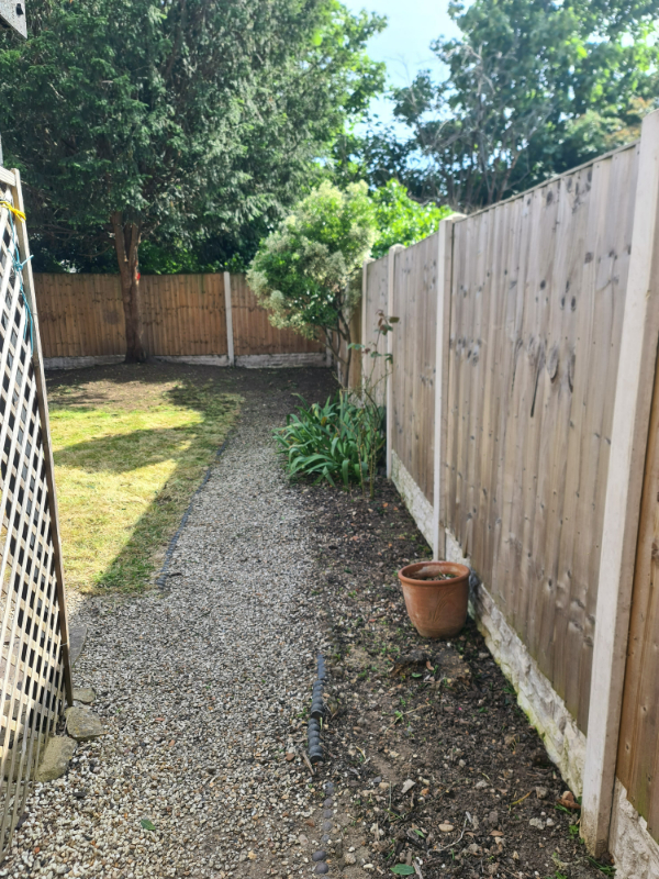 Garden fully cleared with a neat lawn and trimmed hedges in London home