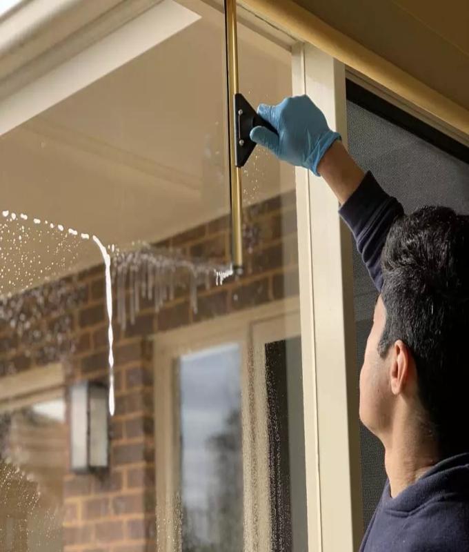 Close-up of a professional window cleaner during a service