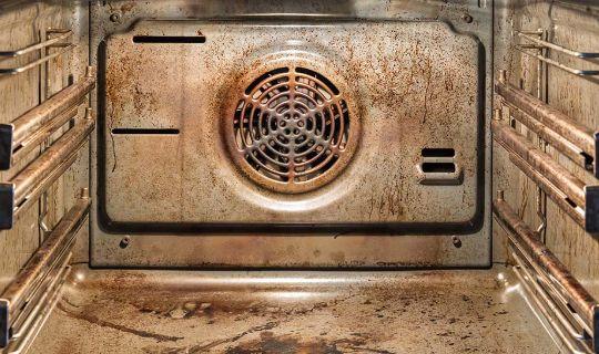 the inside of a very greasy and grimy oven