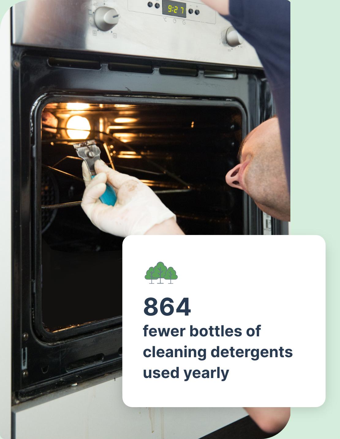 The image shows an open oven with a light bulb on. An oven cleaning technician is reaching inside the oven chamber and cleaning it.