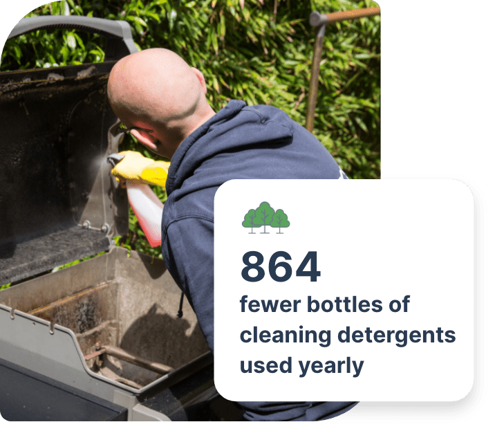 The image shows a Fantastic Services cleaner who is spraying a filthy barbecue unit with a spray bottle in order to dissolve the accumulated gunk and grime.