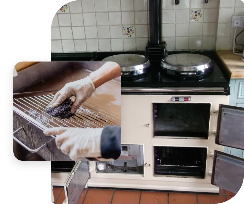 The image shows an AGA range cooker that is being thoroughly cleaned by a professional technician.