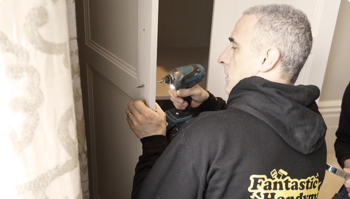handyman measuring door handle