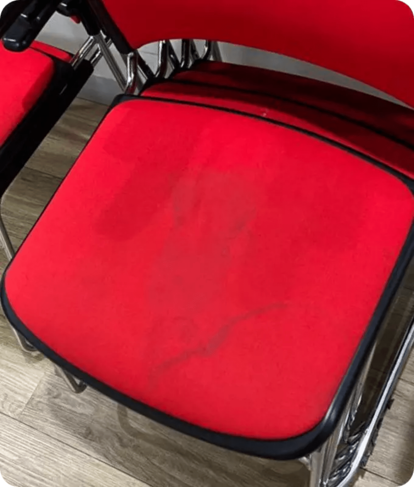 Picture of a red upholstered chair with stains on it