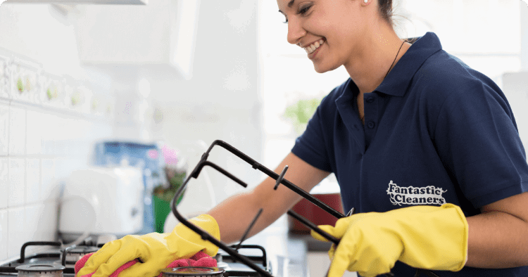 professional cleaner in the process of cleaning a kitchen countertop