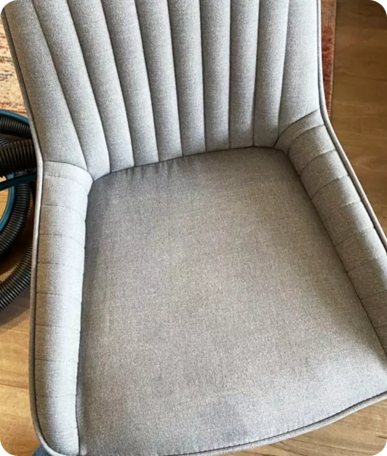 Close-up view of a grey upholstered chair after professional upholstery cleaning service