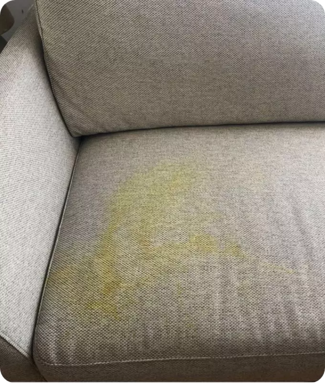 Grey upholstery with yellow stains on it