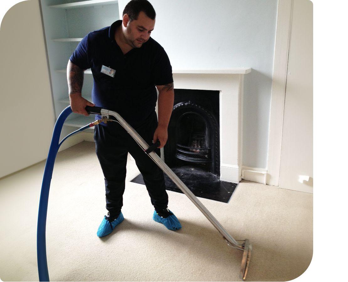 Fantastic Services Carpet Technician focusing on cleaning a carpet with extreme care